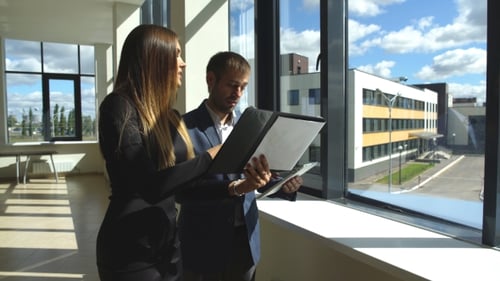 Businesswoman And Businessman Walking On Office And Discuss Ideas
