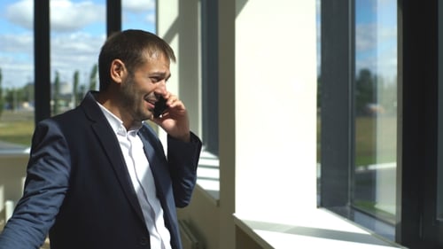 Serious Businessman Arguing on The Phone in The Office
