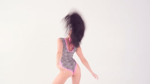 Young Woman Dancing Energetically in Studio