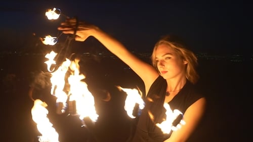 Fire Dancer Performing at Night in Urban Setting