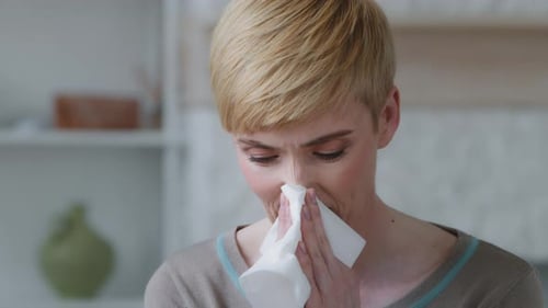 Woman Uses Tissue Indoors, Close Up