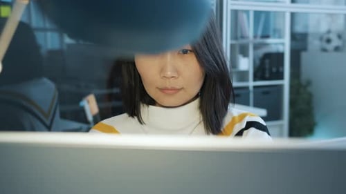 Young Woman Working on Computer in Modern Office