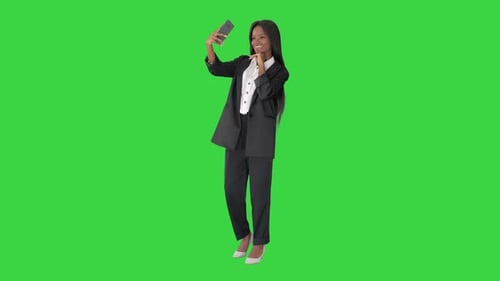 Pretty African Amerivan Female Making Selfie on Her Phone on a Green Screen, Chroma Key