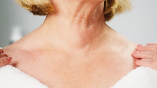 Woman Massaging Her Neck and Shoulders Close Up