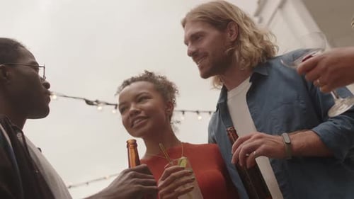 Friends Talking and Drinking at Urban Gathering