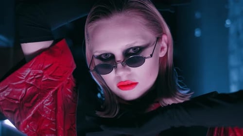 Stylish Woman with Sunglasses Posing in Futuristic Setting