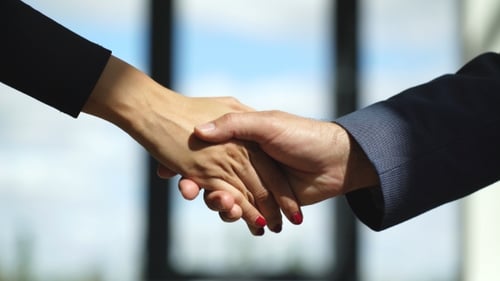 Business People Handshake in Modern Office Setting