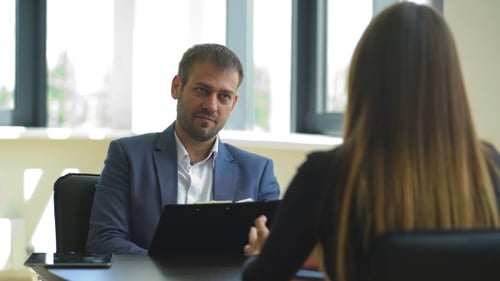 Corporate Meeting with Man Gesturing in Modern Office