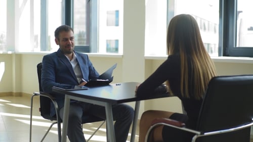 Smiling The Employer Asks Questions To The Woman In The Interview