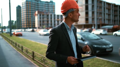 Architect Looking Tablet Pc And Comparing Project With Building