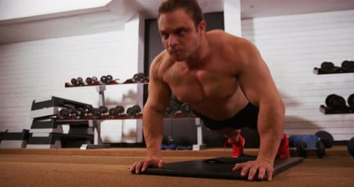 Man Doing Push-Ups at the Gym