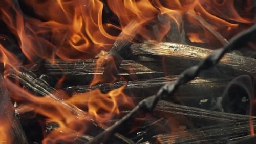 Bright Flames Engulfing Charcoal Pieces