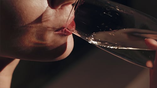 Woman drinking champagne in close up shot