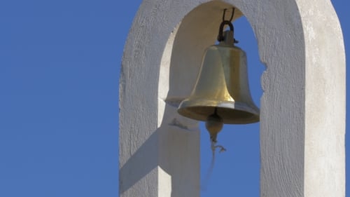 White Bell Tower with Golden Bell Under Blue Sky