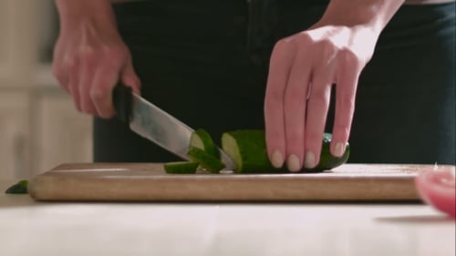 Cucumber Sliced on Cutting Board in Kitchen