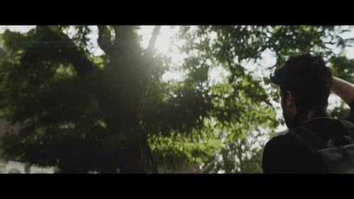 Man Taking Pictures in the Park