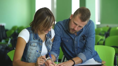 Students Write Notes in Classroom Setting