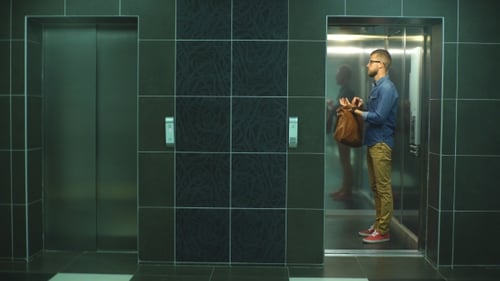 Man Enters Elevator in Urban Setting