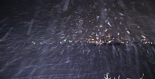 Snowfall Obscures City Lights on a Cold Winter Night