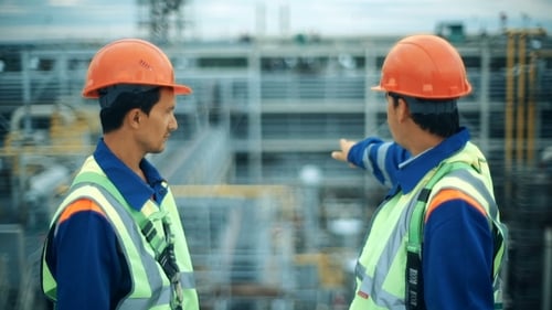 Construction Workers Discussing Building Site Outside