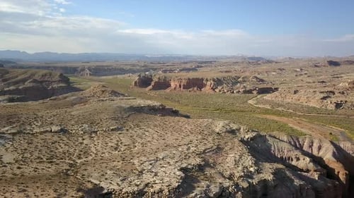 Aerial of desert with small river flowing through it