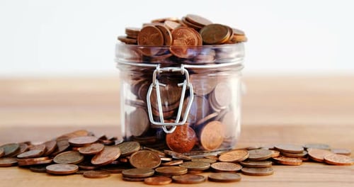 Close-up of coins in bottle