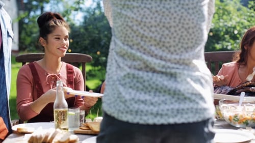 Happy Friends Having Dinner At Summer Garden Party