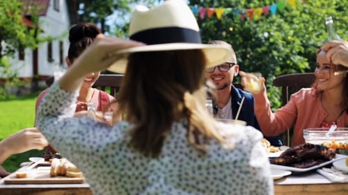 Happy Friends Having Dinner At Summer Garden Party