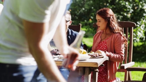 Happy Friends At Barbecue Party In Summer Garden