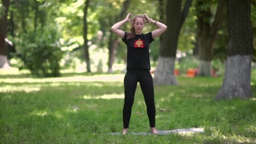 Woman Practicing Yoga in a Green Park