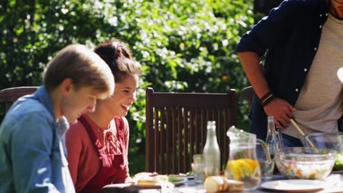 Friends Gathering For Dinner At Summer Garden