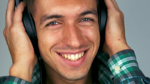 Smiling man with headphones looking at the camera