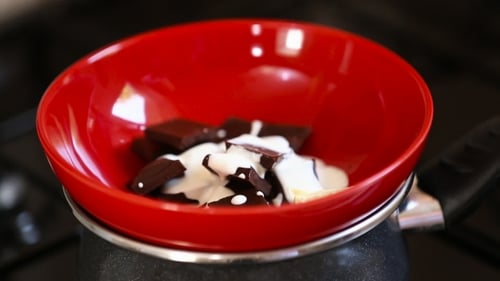 Butter Being Added to Bowl with Chocolate