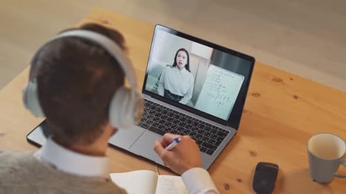 Student Attending Online Class, Taking Notes at Home