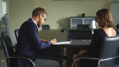 Cute Businesswoman Getting His Client To Sign a Contract And Close a Deal During a Meeting