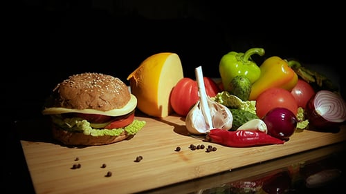 Burger Assembly with Fresh Ingredients on Wood Cutting Board