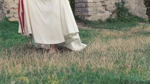 Bride in White Dress with Flowers Outdoors