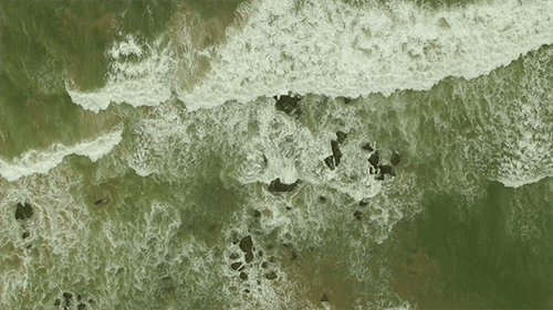 Hovering Above Ocean Waves and Rocks