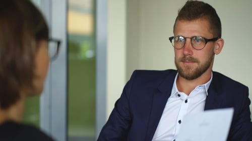 Young Businessman Discussing the Terms of the Contract With Businesswoman in Office