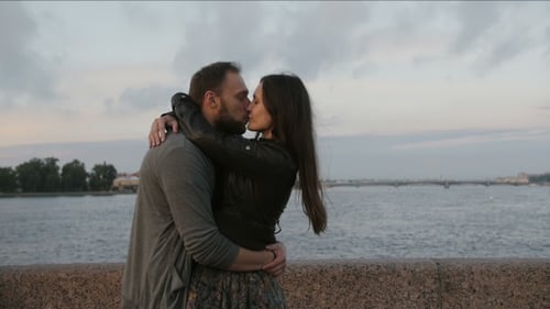 Loving Couple Embracing by the Waterfront