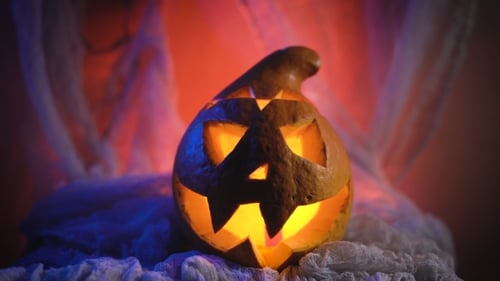 Halloween Pumpkin Carved with Glowing Face on Cloth