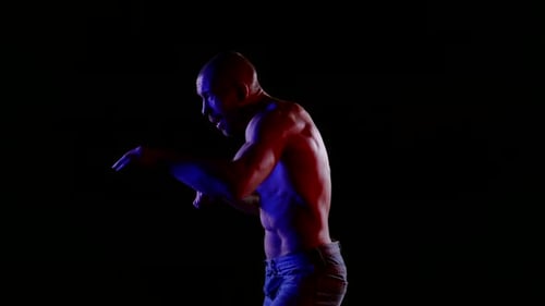 Fighter in Night Man is Punching By Arms to Air Training Alone in Darkness