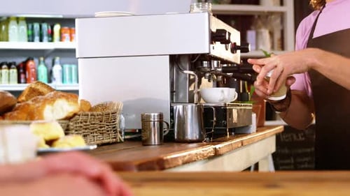 Barista Prepares Coffee in Cafe for Customer