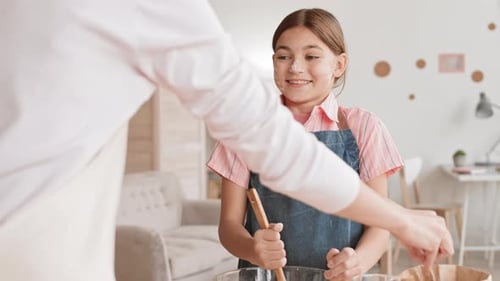 Girl Baking with an Adult in Home Kitchen