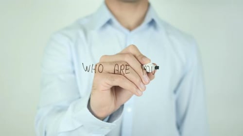 Hand Writes "Who Are You?" with Black Marker