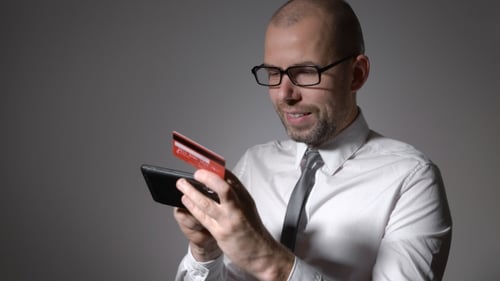 A Man With a Beard Businessman Holding a Mobile Phone And The Hands Of The Credit Card.