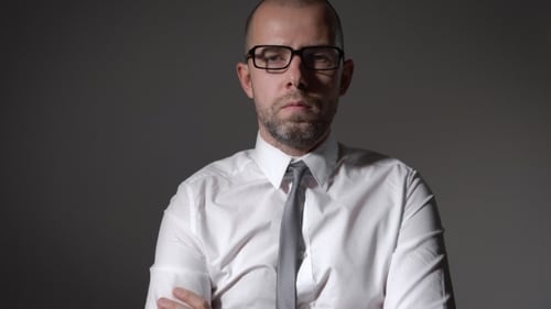 Portrait Of Handsome Businessman Standing On Grey Background