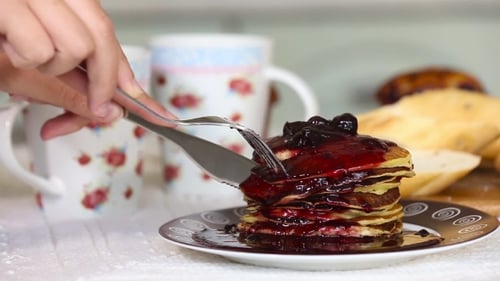 Fork Pierces Blueberry Pancakes with Silverware