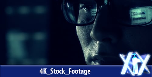 Man With Glasses Working at Computer in Dark