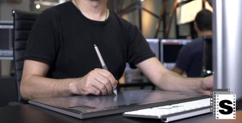 Man Working on Computer and Tablet in Office